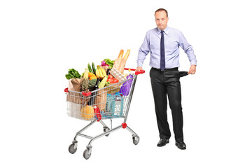 Bankrupt man holding a shopping cart and gesturing no more money