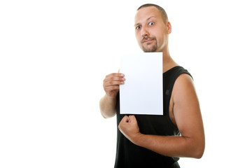 workout young guy showing his muscles and white paper