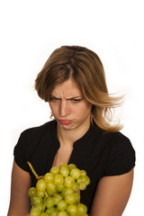 young woman holding green fruit over white background