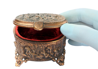 gloved hand, opening a copper box for jewelry