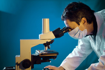 scientific looking in microscope