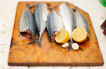 Fish carcass with spices on wooden hardboard, prepared for cooki