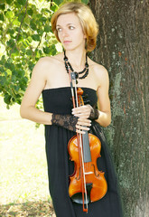 Pretty young woman with violin outdoor