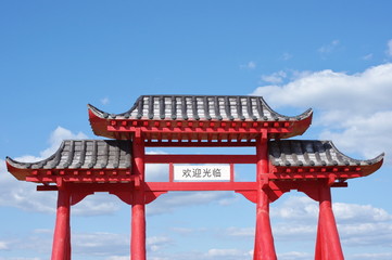 Gate of Buddhist temple and blue sky with clouds