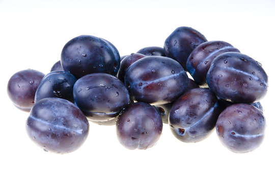 Stack of blue plums isolated