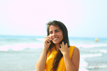 Smiling young lady talking on a cellphone