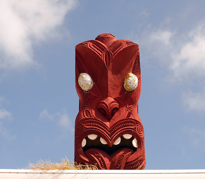 Red carved head with white eyes