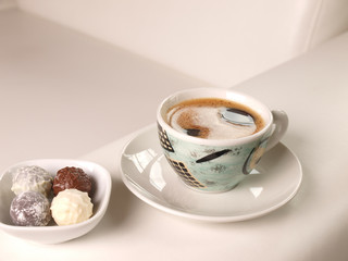 Cup of coffee on a luxury white leather couch