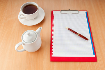 Binder with blank page and tea