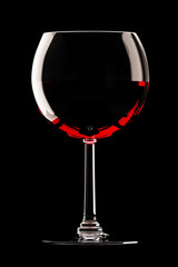glass of red wine on black background