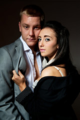 Young couple against black