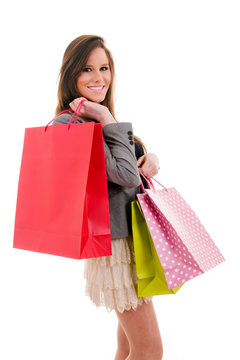 Smiling beautiful young woman with shopping bags, isolated on wh
