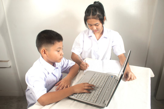 Brother and sister learning  computer.