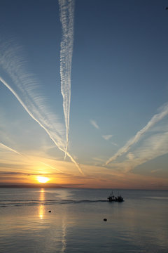 Fishing boat leaving Mevagissey harbour in the early morning
