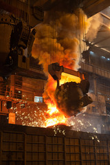 Smelting metal in metallurgical plant. Liquid iron from ladle