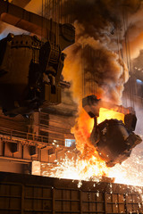 Smelting metal in metallurgical plant. Liquid iron from ladle