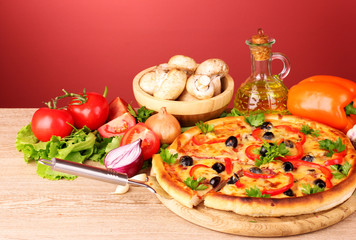 pizza and vegetables on a red background
