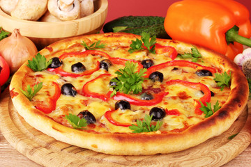 pizza and vegetables on red background