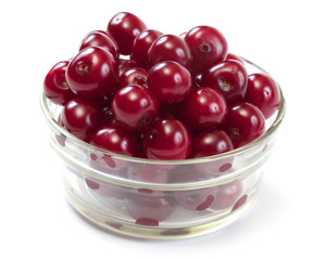 Bowl with ripe cherries. Isolated on a white background.