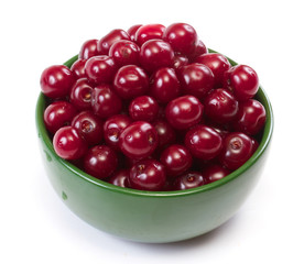 Bowl with ripe cherries. Isolated on a white background.