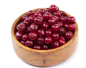 Bowl with ripe cherries. Isolated on a white background.
