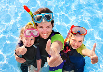 Children with mother  in swimming pool.