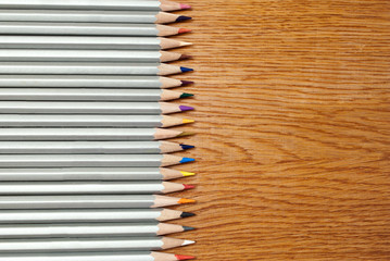 Fototapeta premium Set of pencils on a wooden background.