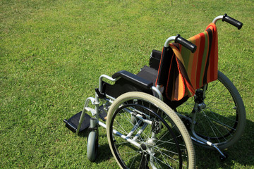 empty wheelchair over green grass