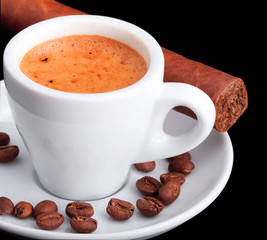 Coffee and a cigar on a black background