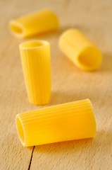 Rigatoni pasta on a wooden board