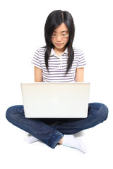 Young chinese woman sitting on the floor with laptop