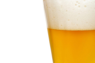 Glass of beer closeup with froth