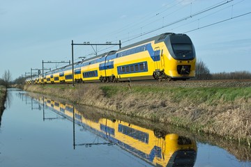 Dutch train en route along canal