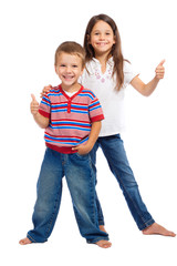 Two funny smiling little children with thumbs up sign