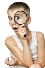 Surprised boy with magnifying glass