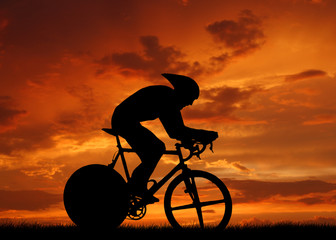 Road cycler silhouette in sunrise