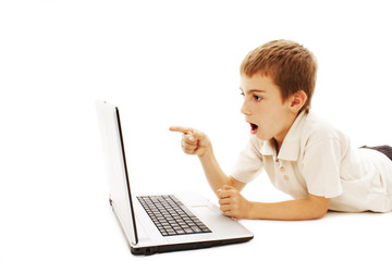 Surprised boy with laptop. Pointing at it