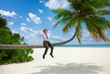 Happy businessman sitting on the palm and relax