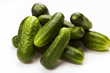 Pile of fresh cucumbers on White