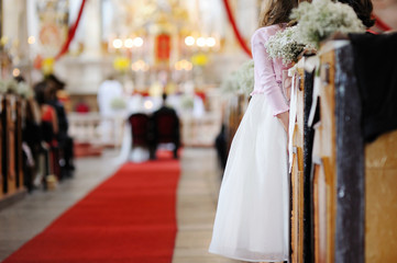 Girl in a white dress watching wedding ceremony