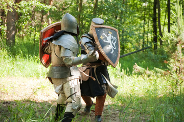 Two knights  is fighting  at forest