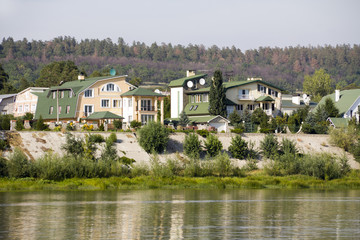 Fototapeta na wymiar Beautiful cottages on river bank