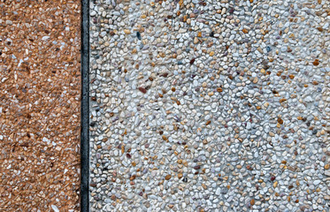 An image of a concrete wall covered by pebble dash.