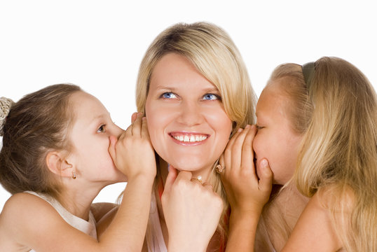 mom  with daughters whispering
