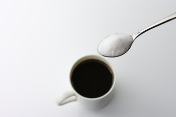 Black coffee and spoonful of sugar