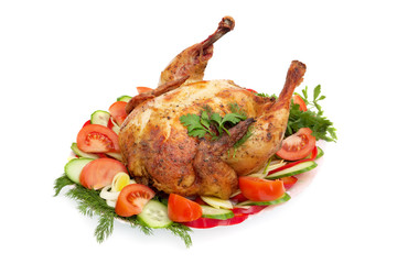 roast chicken with vegetables on a plate isolated on white