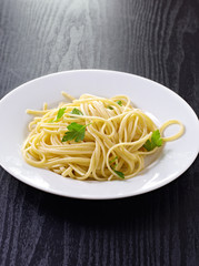 plate of fresh plain pasta with parsley