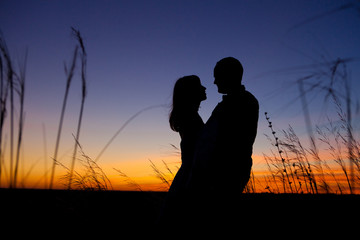 Fototapeta na wymiar Couple on the sunset background.