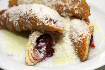 pancakes with cherry and jam on plate