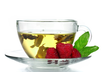 green tea in transparent cup and raspberry isolated on white
